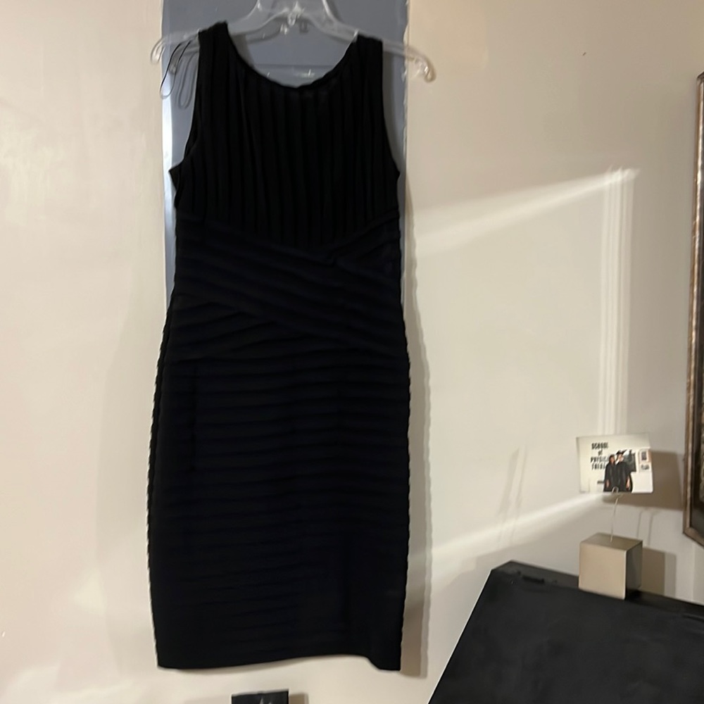 Calvin Klein sleeveless black dress with crisscross details at the waist